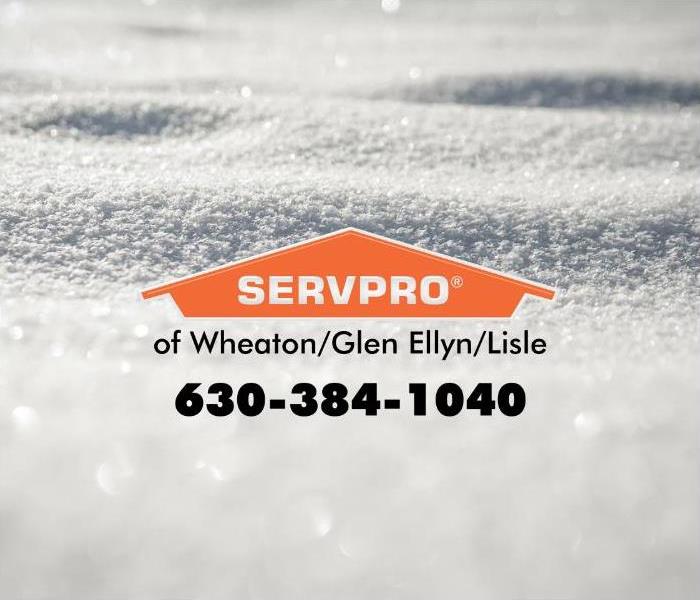A blanket of snow with an orange SERVPRO logo.