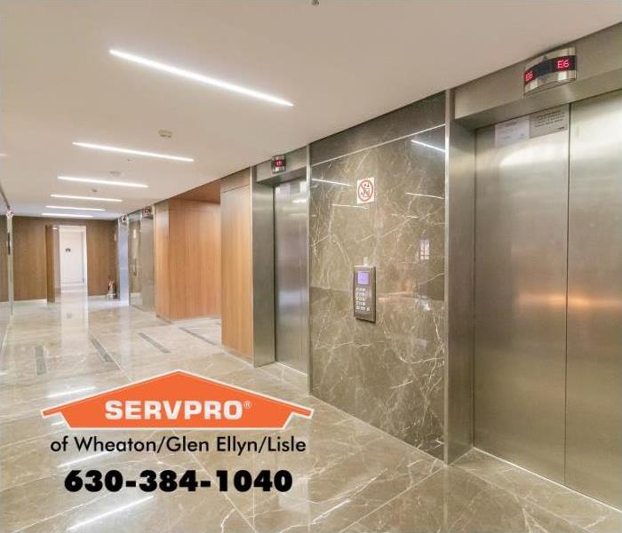 Silver elevator doors in an office hallway.