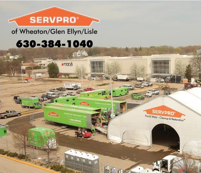 Ariel view of green SERVPRO trucks in a parking lot of a mall.