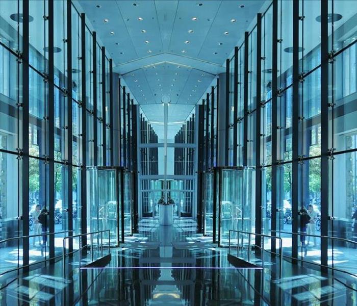Lobby of an office building that has glass walls on each side.