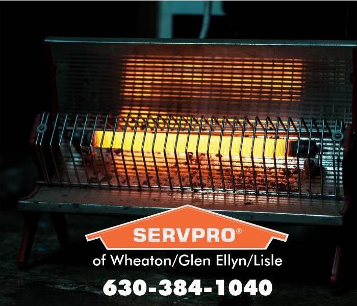 Hot space heater with a metal cage with a orange SERVPRO logo.
