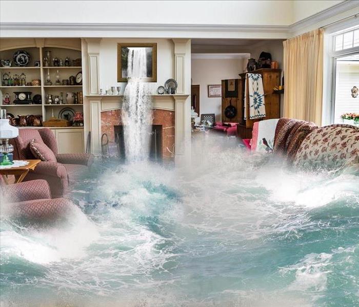 Flooded living room with red chairs and a floral couch under water and water flowing from a picture above a fireplace.